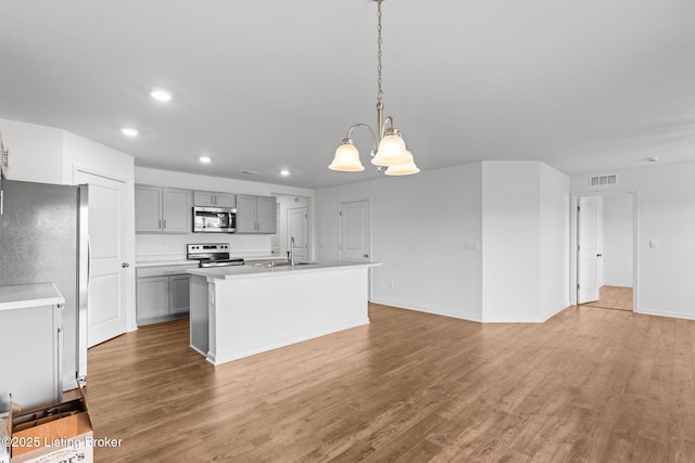 243 Zelcova Dr, Eminence, KY 40019 - kitchen with a chandelier, gray cabinetry, light wood-style floors, appliances with stainless steel finishes, and a sink