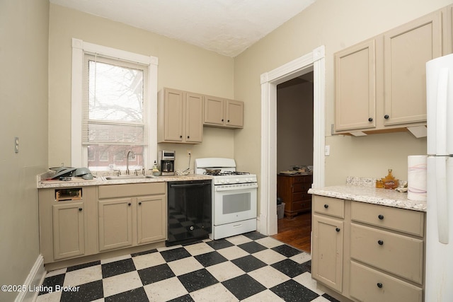 kitchen featuring light countertops, light floors, a sink, and white appliances