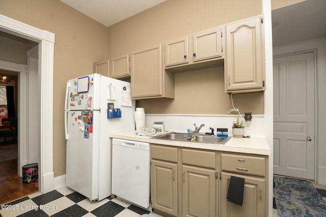 kitchen with light countertops, a sink, light floors, baseboards, and white appliances