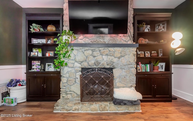 living area featuring wood finished floors and a fireplace