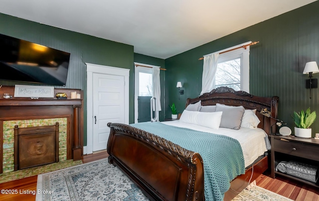 bedroom featuring wood finished floors and multiple windows