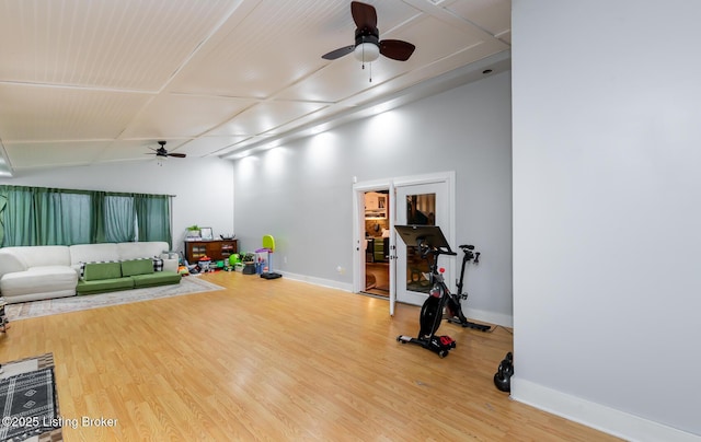 workout room featuring wood finished floors, baseboards, and a ceiling fan