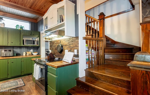 kitchen featuring open shelves, appliances with stainless steel finishes, wood finished floors, wooden counters, and green cabinetry