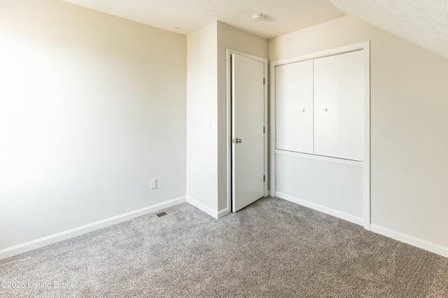 unfurnished bedroom featuring baseboards, a closet, and carpet