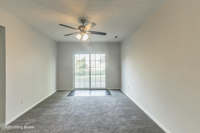 carpeted spare room featuring a ceiling fan, baseboards, and a textured ceiling