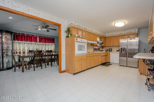 3019 Leman Dr, Louisville, KY 40220 - kitchen with wallpapered walls, light countertops, white appliances, and under cabinet range hood