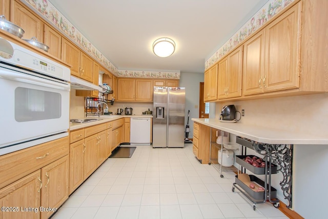 3019 Leman Dr, Louisville, KY 40220 - kitchen with light brown cabinets, under cabinet range hood, light countertops, and white appliances