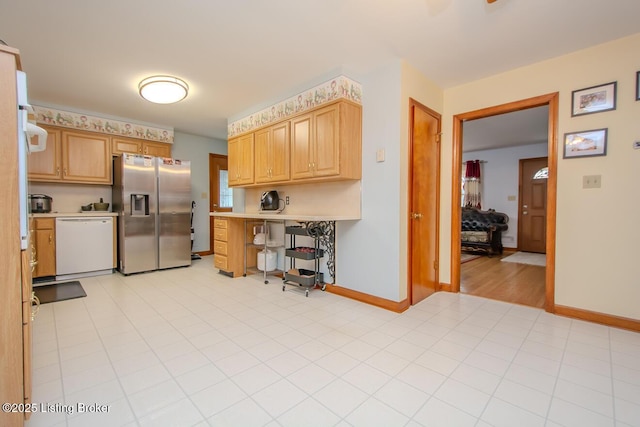3019 Leman Dr, Louisville, KY 40220 - kitchen with stainless steel fridge with ice dispenser, baseboards, dishwasher, light countertops, and light brown cabinetry