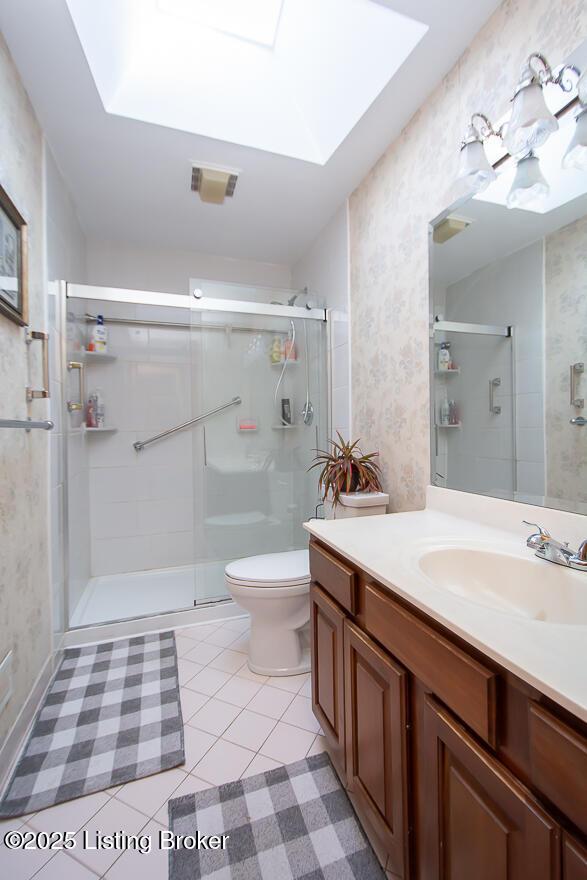 3019 Leman Dr, Louisville, KY 40220 - full bath with a shower stall, vanity, visible vents, toilet, and a skylight