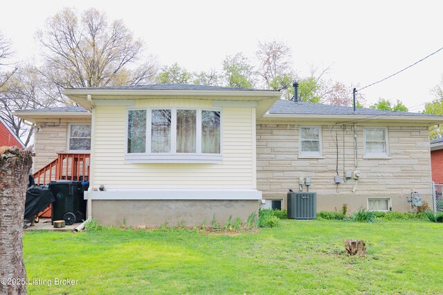 3019 Leman Dr, Louisville, KY 40220 - rear view of property with stone siding, a lawn, and central air condition unit