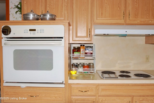 3019 Leman Dr, Louisville, KY 40220 - kitchen with under cabinet range hood, white appliances, and light countertops