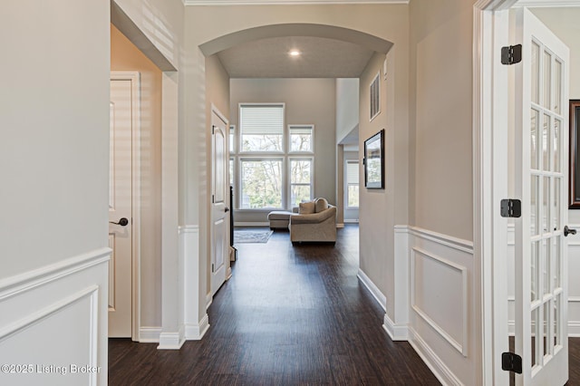 18104 Bridle Run Dr, Louisville, KY 40245 - hallway with arched walkways, a decorative wall, dark wood-style floors, and a wainscoted wall