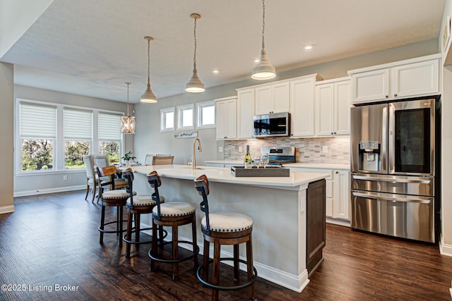 18104 Bridle Run Dr, Louisville, KY 40245 - kitchen with backsplash, recessed lighting, appliances with stainless steel finishes, a kitchen island with sink, and dark wood-style floors