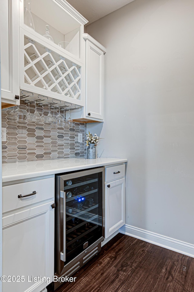 18104 Bridle Run Dr, Louisville, KY 40245 - bar featuring baseboards, a dry bar, wine cooler, dark wood-type flooring, and decorative backsplash