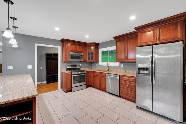 1468 Lakeshore Pkwy, Brandenburg, KY 40108 - kitchen featuring appliances with stainless steel finishes, light stone counters, decorative light fixtures, glass insert cabinets, and recessed lighting
