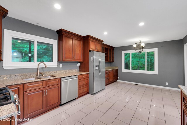 1468 Lakeshore Pkwy, Brandenburg, KY 40108 - kitchen featuring appliances with stainless steel finishes, light stone counters, brown cabinets, recessed lighting, and a chandelier