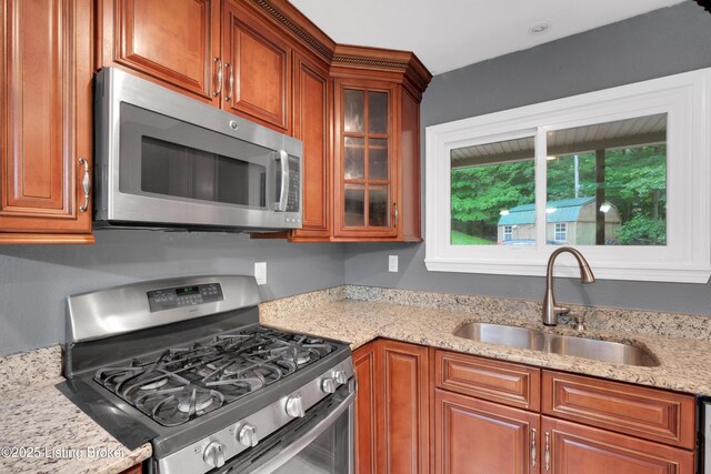 1468 Lakeshore Pkwy, Brandenburg, KY 40108 - kitchen with appliances with stainless steel finishes, glass insert cabinets, light stone countertops, and brown cabinets