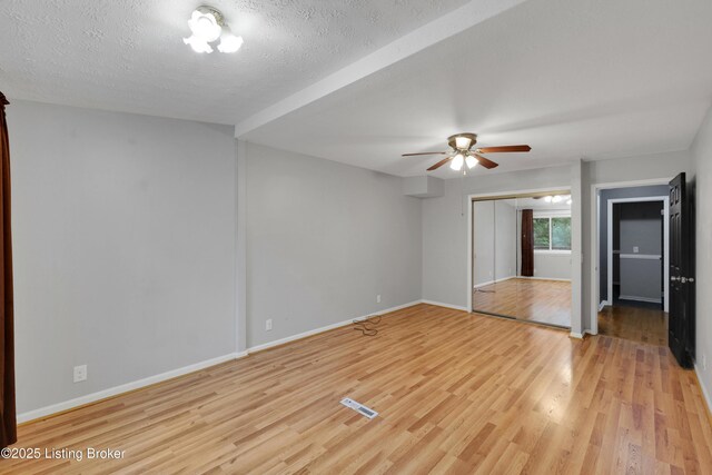 1468 Lakeshore Pkwy, Brandenburg, KY 40108 - unfurnished bedroom featuring light wood-type flooring, a closet, a ceiling fan, and a textured ceiling