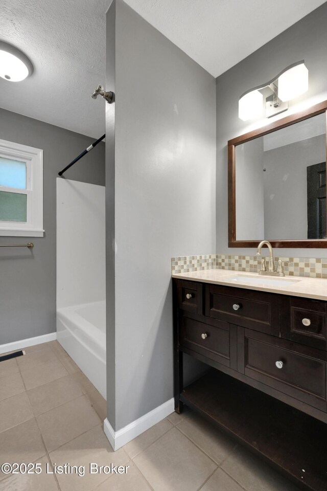 1468 Lakeshore Pkwy, Brandenburg, KY 40108 - full bath featuring vanity, tile patterned flooring, tub / shower combination, decorative backsplash, and a textured ceiling