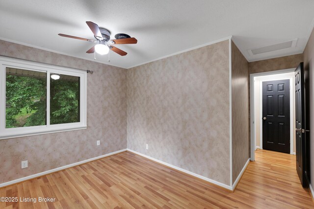 1468 Lakeshore Pkwy, Brandenburg, KY 40108 - spare room featuring wood finished floors, a ceiling fan, and attic access