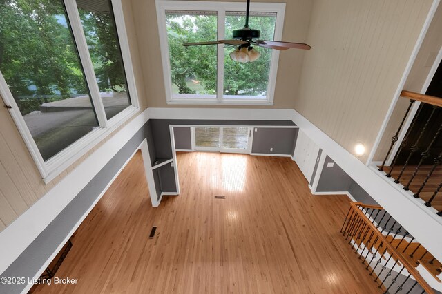 1468 Lakeshore Pkwy, Brandenburg, KY 40108 - unfurnished living room featuring a ceiling fan, wood finished floors, and healthy amount of natural light