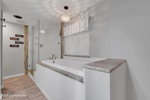 1468 Lakeshore Pkwy, Brandenburg, KY 40108 - full bathroom with a garden tub, a shower stall, and wood finished floors