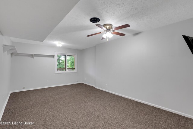 1468 Lakeshore Pkwy, Brandenburg, KY 40108 - empty room with a ceiling fan, dark colored carpet, and a textured ceiling