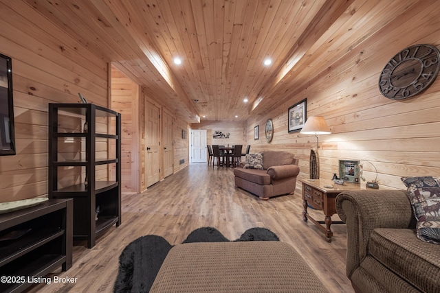 living area with wood finished floors, recessed lighting, wood ceiling, and wood walls