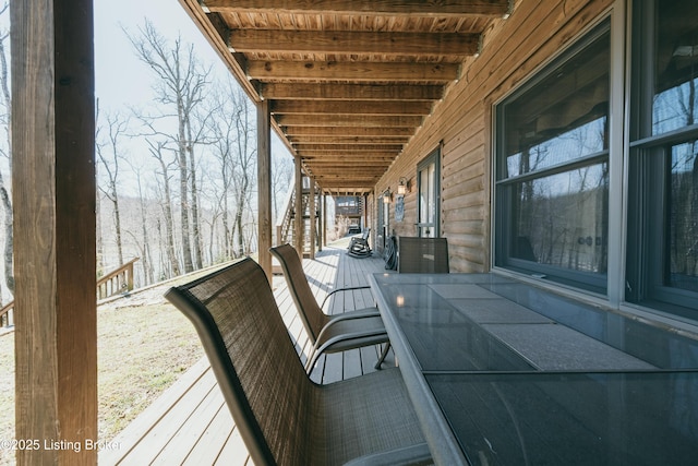 wooden terrace with outdoor dining area