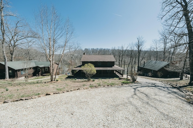 view of street with gravel driveway