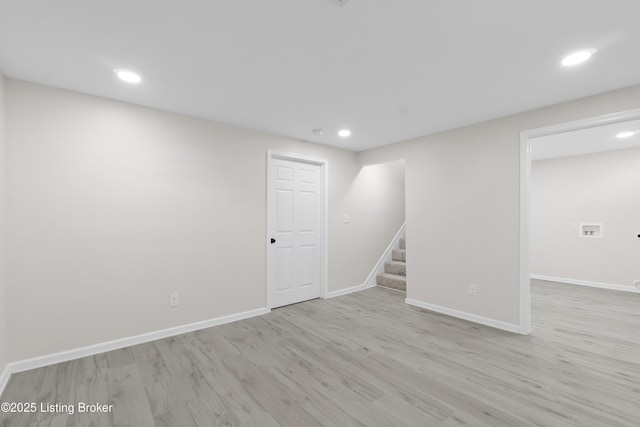 interior space featuring recessed lighting, baseboards, stairs, and wood finished floors