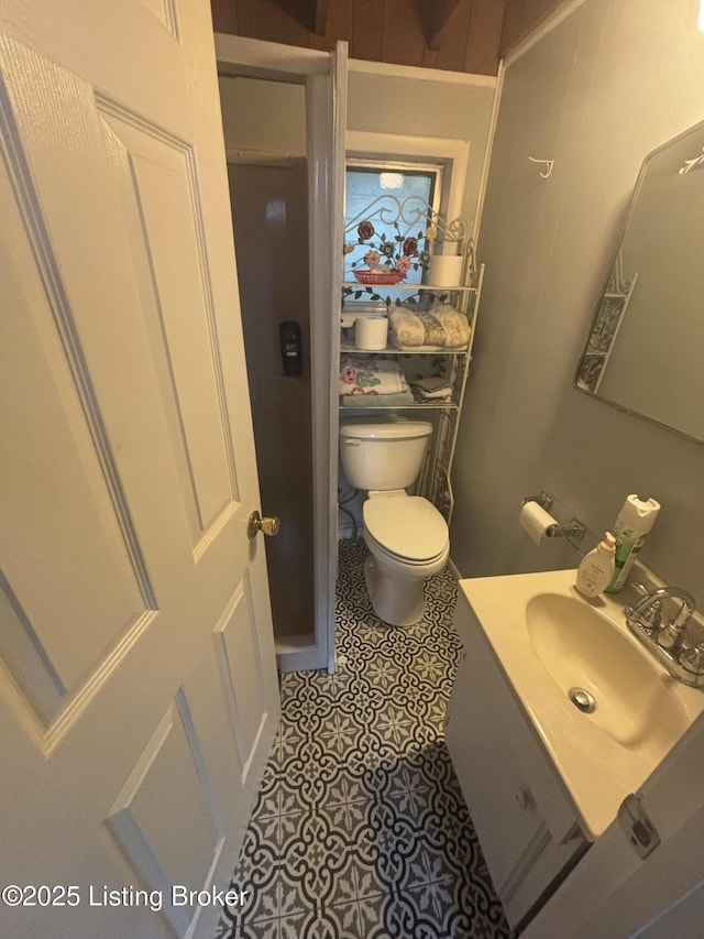 1009 Wilderness Rd, Mammoth Cave, KY 42259 - half bathroom featuring vanity, toilet, and tile patterned flooring