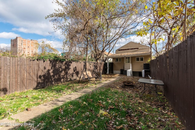 view of yard with an outbuilding and a fenced backyard