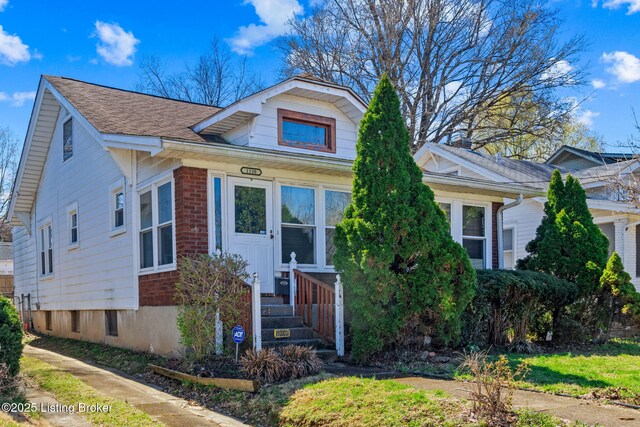 bungalow-style house with brick siding