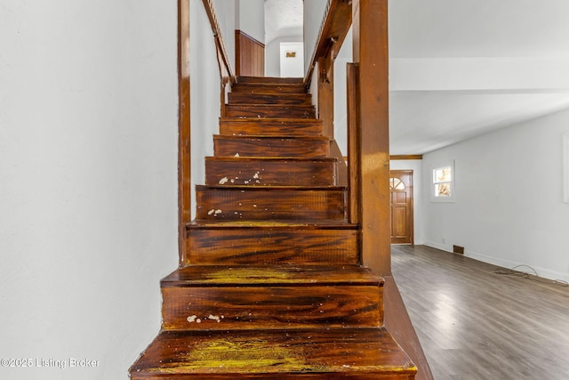 stairs with baseboards and wood finished floors