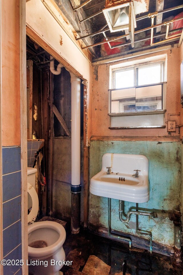 half bathroom with toilet and a sink
