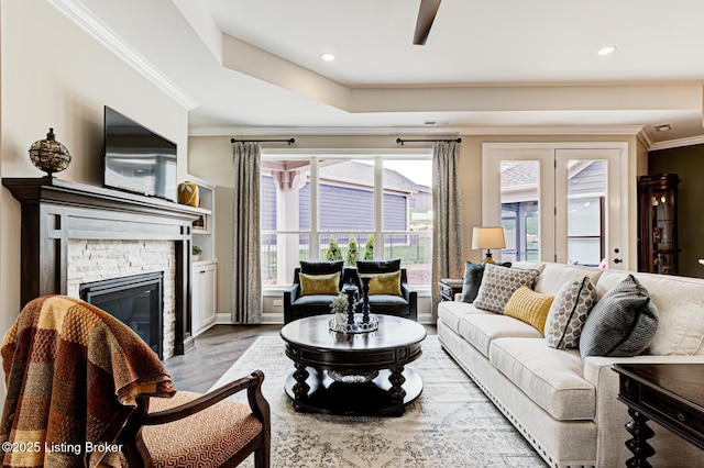 living room with recessed lighting, a fireplace, crown molding, a ceiling fan, and wood finished floors