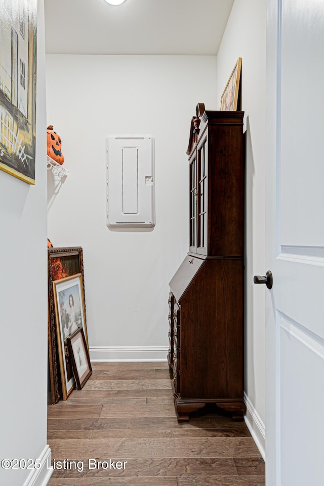 stairway with baseboards and wood finished floors