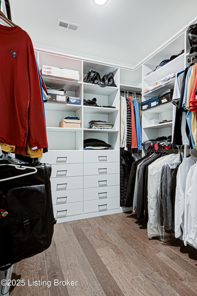 spacious closet with visible vents and wood finished floors