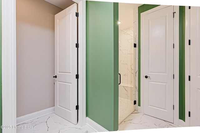 full bathroom with a marble finish shower, baseboards, and marble finish floor