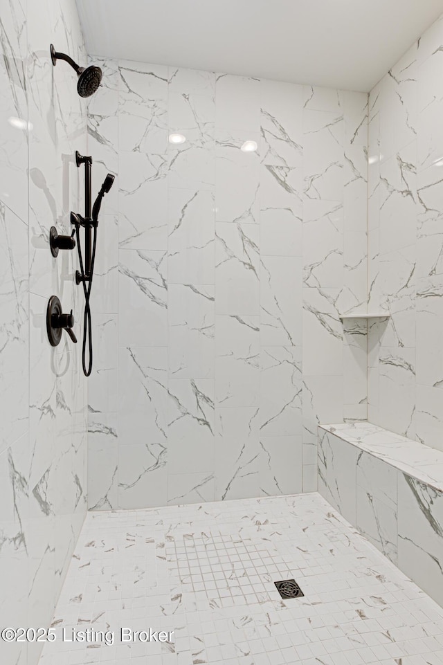 bathroom with a tile shower