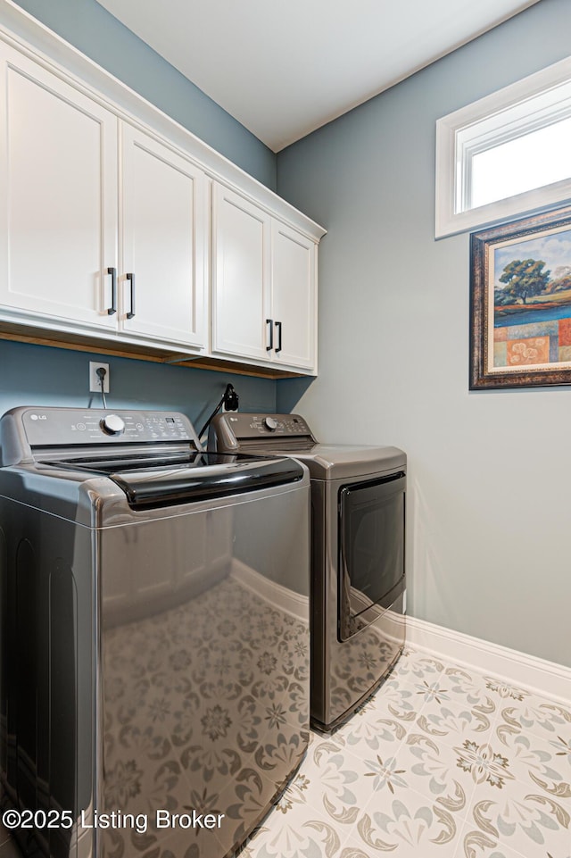 laundry area with cabinet space, baseboards, and separate washer and dryer