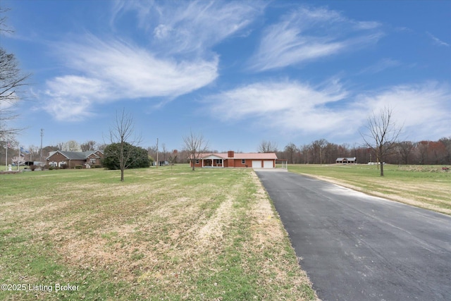 1109 Holly Ave, Louisville, KY 40118 - single story home with an attached garage, asphalt driveway, and a front yard
