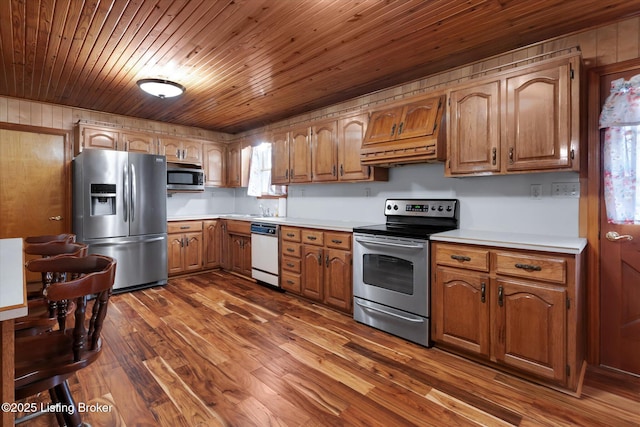 1109 Holly Ave, Louisville, KY 40118 - kitchen with appliances with stainless steel finishes, premium range hood, light countertops, brown cabinets, and wooden ceiling