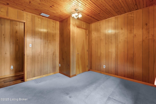 1109 Holly Ave, Louisville, KY 40118 - unfurnished room with carpet flooring, wood ceiling, wooden walls, a chandelier, and baseboards