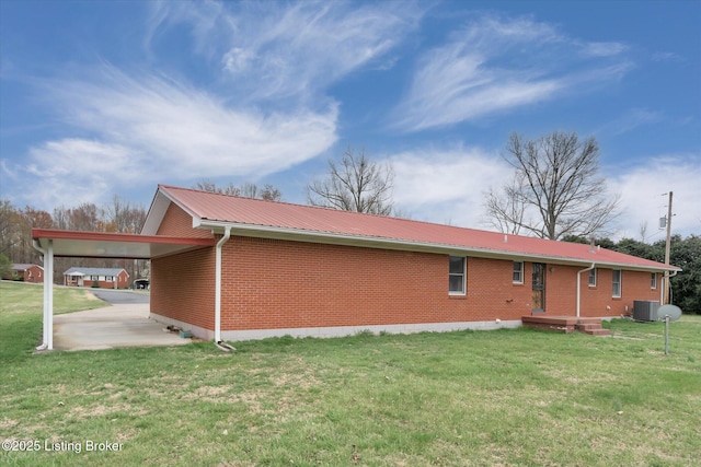 1109 Holly Ave, Louisville, KY 40118 - back of property featuring an attached carport, brick siding, a lawn, and metal roof