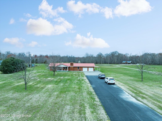 1109 Holly Ave, Louisville, KY 40118 - view of front of house with driveway, a garage, a front yard, and a chimney