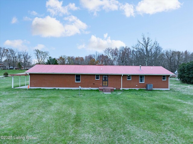 1109 Holly Ave, Louisville, KY 40118 - back of house featuring central air condition unit, metal roof, a yard, and brick siding