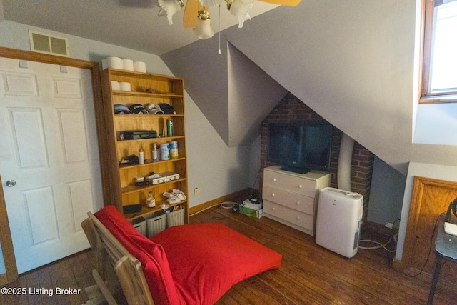 bedroom featuring visible vents, vaulted ceiling, and wood finished floors
