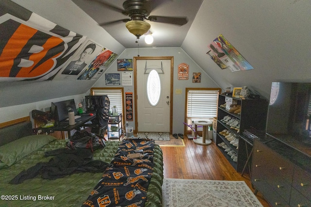interior space featuring vaulted ceiling, a ceiling fan, and wood-type flooring